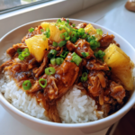 Sweet Hawaiian Crockpot Chicken served over white rice with pineapple and green onions.