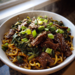 Savory slow cooker Korean beef noodles topped with fresh green onions and sesame seeds.