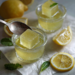 Easy lemon gelatin cubes in glass jars for a low-calorie weight loss snack.