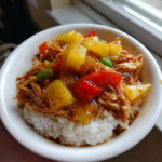 Sweet Hawaiian crockpot chicken with pineapple and bell peppers served over white rice.